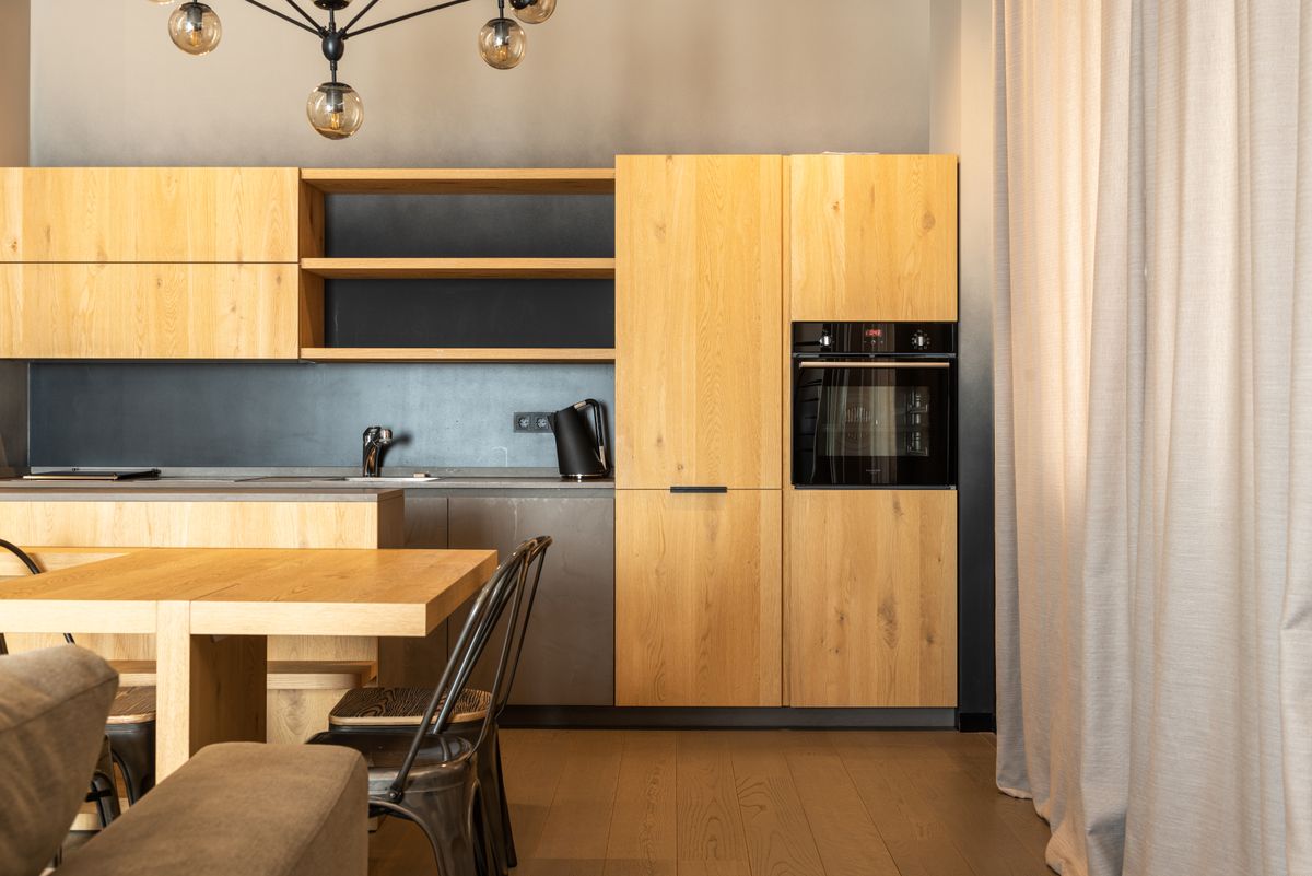 A renovated kitchen with warm wood cabinets and modern appliances