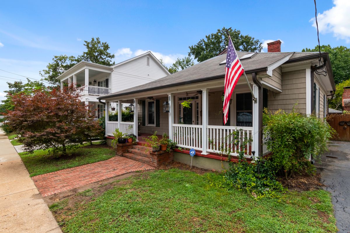A welcoming home with a covered front porch on a tree-lined street